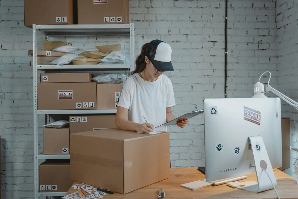 Entrepreneur managing shipping logistics and stock for her webshop